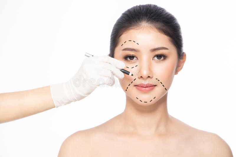 Lines on face, close up, plastic surgery concept, doctor`s hand in glove making marks on patient`s face..Asian beauty  Woman in