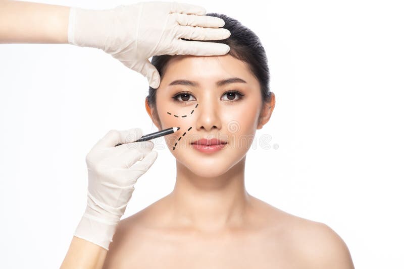 Lines on face, close up, plastic surgery concept, doctor`s hand in glove making marks on patient`s face..Asian beauty  Woman in