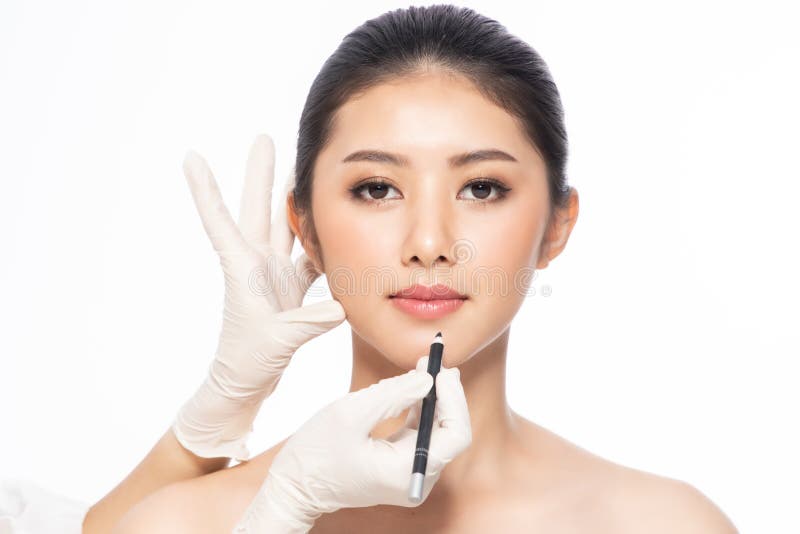 Lines on face, close up, plastic surgery concept, doctor`s hand in glove making marks on patient`s face..Asian beauty  Woman in