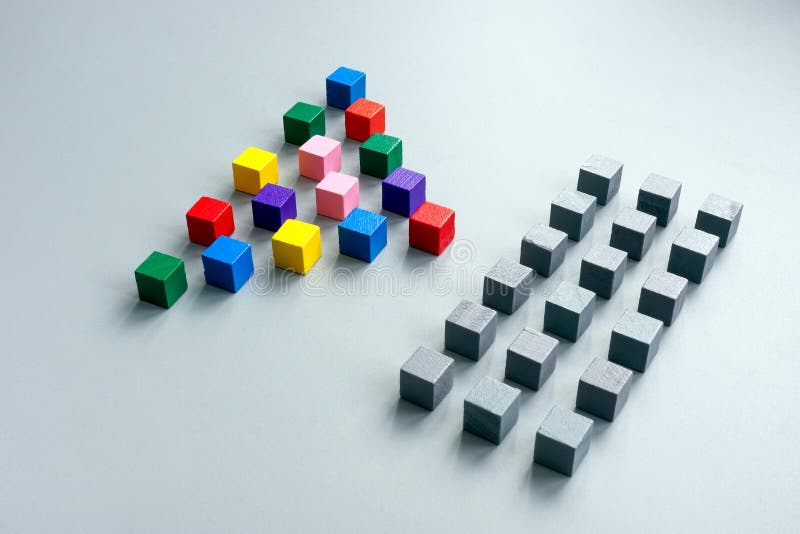 Lines of gray cubes and a pyramid of multi-colored ones as a concept of diversity. stock photo