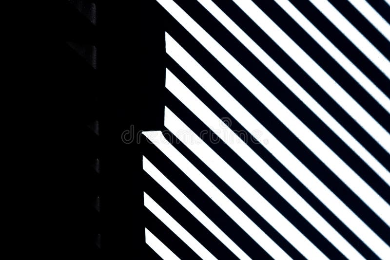 Lines and white stripes on black background with stone texture, copy space.