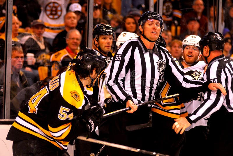 NHL linesman Shane Heyer (55) separates Boston Bruins defenseman Adam McQuaid (54) and Pittsburgh Penguins forward Tyler Kennedy (48). NHL linesman Shane Heyer (55) separates Boston Bruins defenseman Adam McQuaid (54) and Pittsburgh Penguins forward Tyler Kennedy (48).