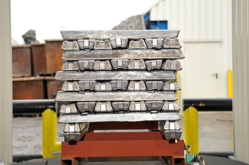 Aluminum ingots stacked on a. Aluminum ingots stacked on a