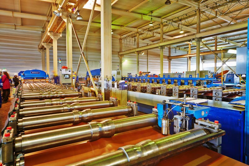 LOBNYA - JUN 7: Automated line for production of metal roofing tile in manufacturing workshop at plant of Group of companies Metal Profile, June 7, 2012, Lobnya, Russia. LOBNYA - JUN 7: Automated line for production of metal roofing tile in manufacturing workshop at plant of Group of companies Metal Profile, June 7, 2012, Lobnya, Russia.