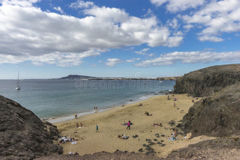 Coast line on Lanzarote with dangerous waves . Canary Island , Spain, Playa Blanca  . And people on the beach. Coast line on Lanzarote with dangerous waves . Canary Island , Spain, Playa Blanca  . And people on the beach.