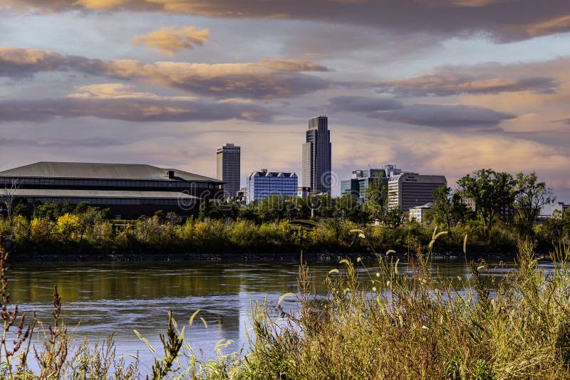 Downtown Omaha Skyline across the Missouri River through colorful Fall, autumn vegetation on the banks of Missouri River. ConAgra, Woodmen Life, Mutual of Omaha, FNBO, Union Pacific and Omaha World Herald buildings are seen towering on the skyline. Replaced skies and clouds. Downtown Omaha Skyline across the Missouri River through colorful Fall, autumn vegetation on the banks of Missouri River. ConAgra, Woodmen Life, Mutual of Omaha, FNBO, Union Pacific and Omaha World Herald buildings are seen towering on the skyline. Replaced skies and clouds