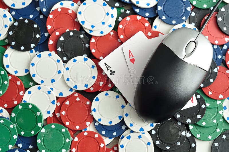 A computer mouse with poker chips and 2 ace cards symbolizing on line poker. A computer mouse with poker chips and 2 ace cards symbolizing on line poker