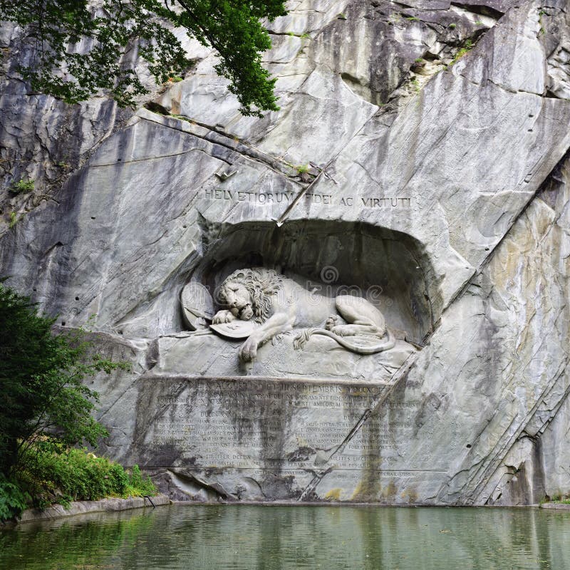 The Lion of Lucerne. The monument of Dying Lion was carved in rock wall by the design of Danish artist Thorwaldsen. It is a World famous tourist attractions. Lucerne, Switzerland. The Lion of Lucerne. The monument of Dying Lion was carved in rock wall by the design of Danish artist Thorwaldsen. It is a World famous tourist attractions. Lucerne, Switzerland