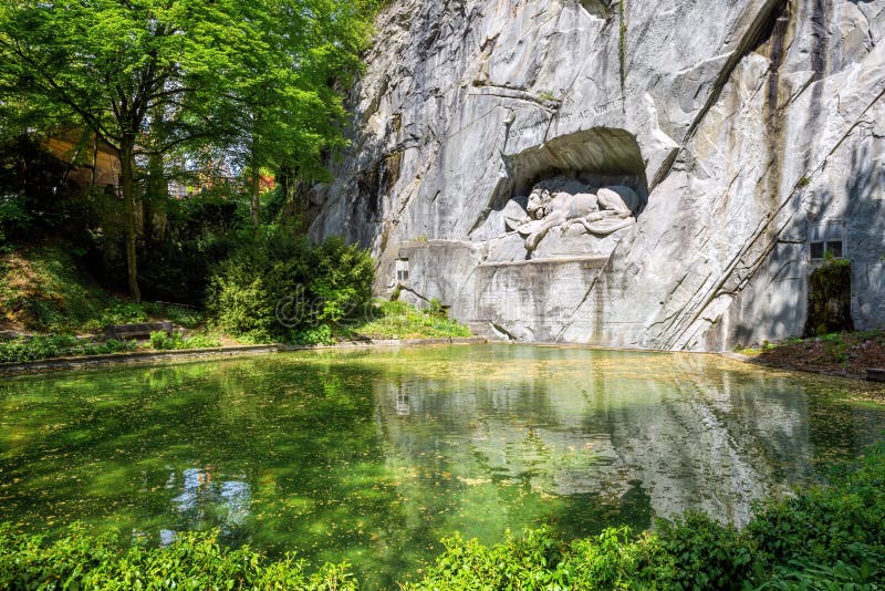 The Lion Monument in Lucerne, Switzerland, carved in a rock in year 1821, is an iconical landmark and symbol of the city. The Lion Monument in Lucerne, Switzerland, carved in a rock in year 1821, is an iconical landmark and symbol of the city