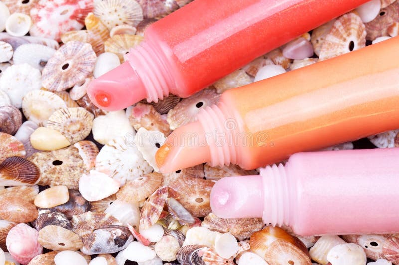 Lip gloss tubes on cockleshell background