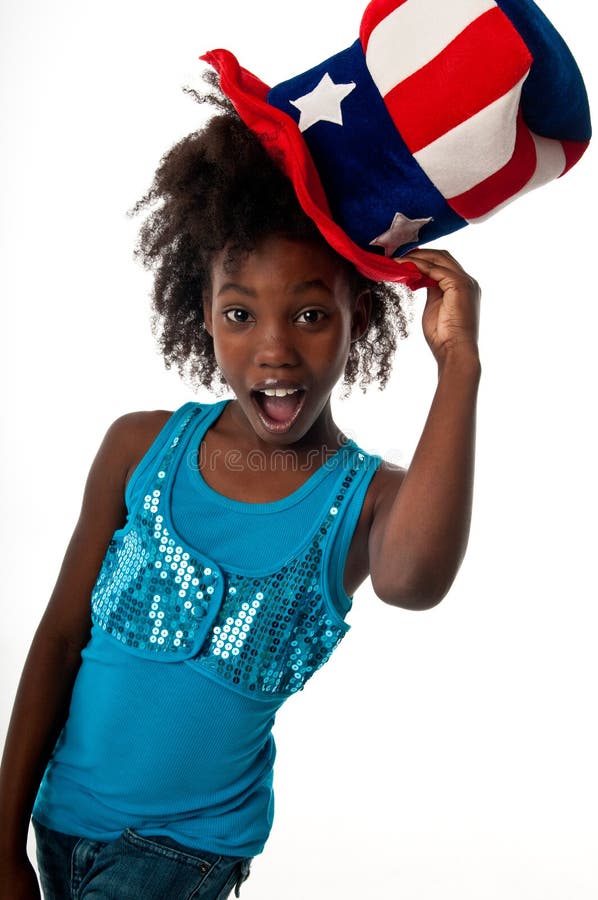 African American girl playing with a very patriotic hat and happy. African American girl playing with a very patriotic hat and happy.