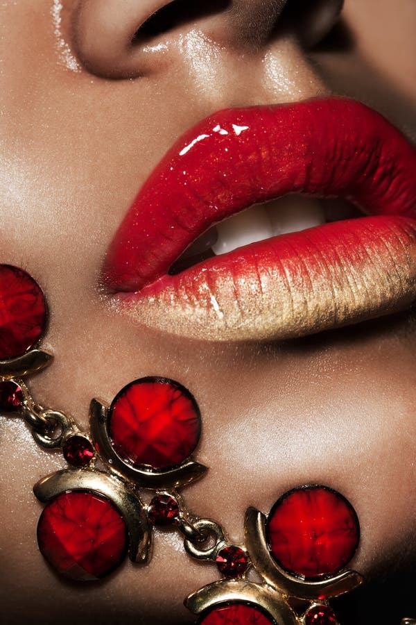 Lips with golden jewelry stock photo. Image of golden 28773528