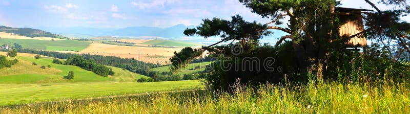 Liptov panorama with Low Tatras Nizke Tatry and Liptovkska Mara water lake reservoir and hunting tower.