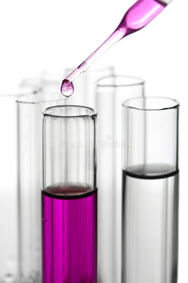 Liquid dripping into test tube isolated