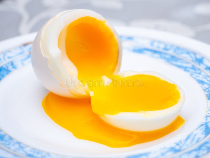 Liquid Egg Yolk Flows Onto a Plate. Stock Photo Image of delicious