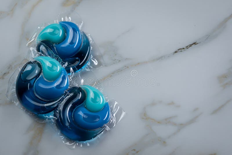 Liquid Laundry Detergent Pods with Gel and Softener in Blue Stock Photo