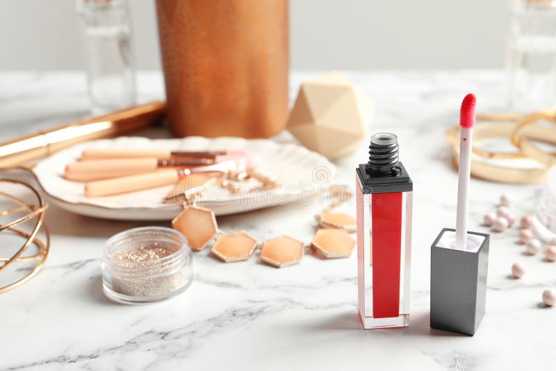 Liquid Lipstick with Applicator and Accessories on Table Stock Photo