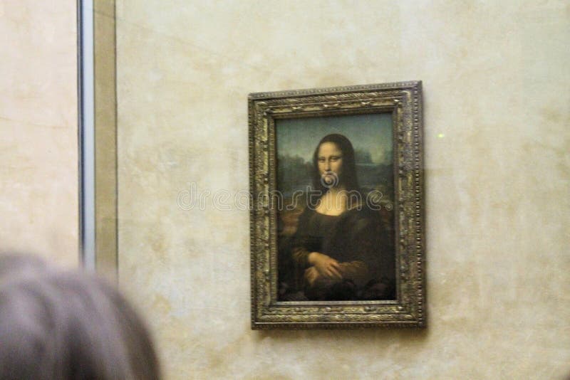 Paris France -04/06/2018 : Leonardo DaVinci`s `Mona Lisa` at the Louvre Museum May 13 2015 in Paris France. The painting is one of the world`s most famous. Paris France -04/06/2018 : Leonardo DaVinci`s `Mona Lisa` at the Louvre Museum May 13 2015 in Paris France. The painting is one of the world`s most famous.