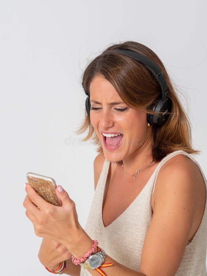 Listening Music with Headphones from a Mobile Phone Stock Photo - Image ...