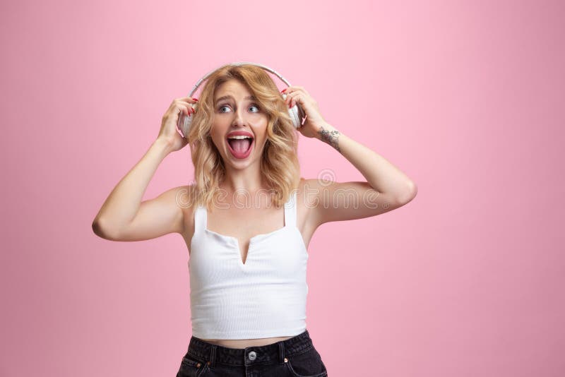 Caucasian young woman`s portrait isolated on pink studio background. Beautiful female model. Concept of human emotions