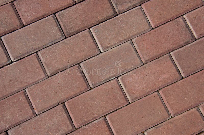 Listras diagonais da textura vermelha da pedra de pavimentação imagens de stock Listras diagonais da textura vermelha da pedra de pavimentação imagens de stock