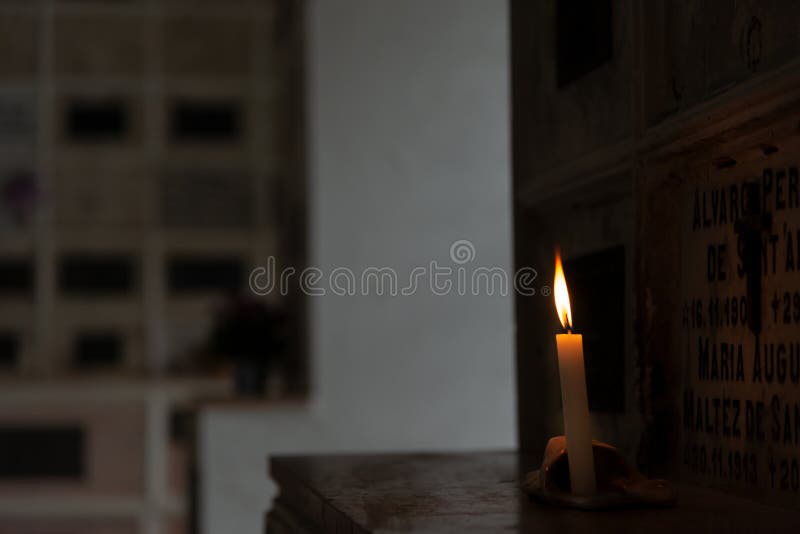 A lit candle inside the Campo Santo cemetery church in the city of Salvador, Bahia