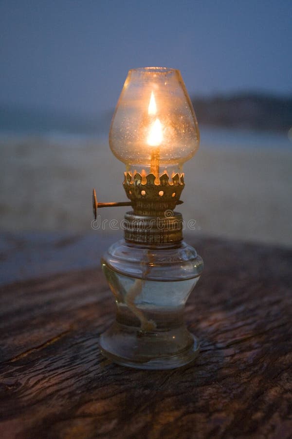 Lit kerosene lantern on beach