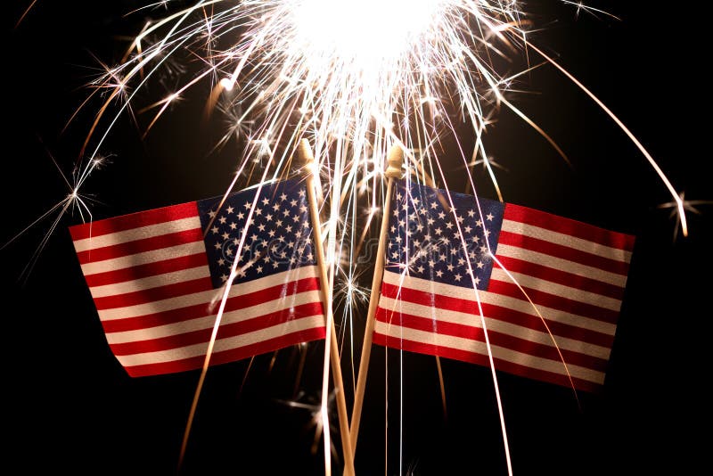 Sparkler Over Two American Flags for 4th of July Celebration Stock