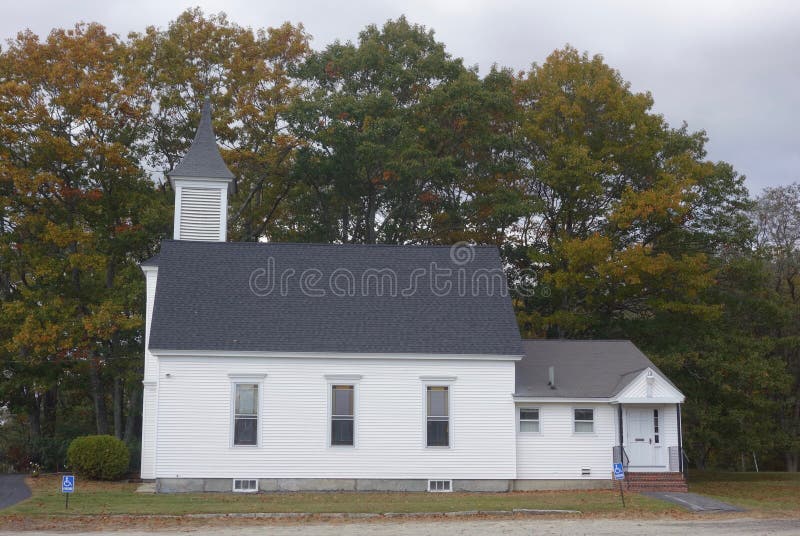 Small white church early autumn with steeple and grey gray roof, Windham, Maine October 25, 2018. Small white church early autumn with steeple and grey gray roof, Windham, Maine October 25, 2018