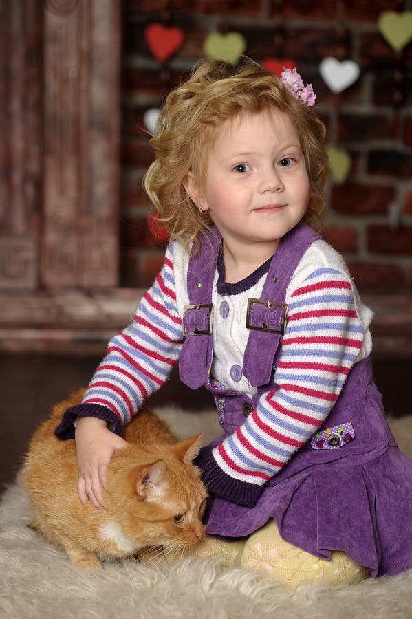 Liten flicka med katten royaltyfri fotografi Liten flicka med katten royaltyfri fotografi