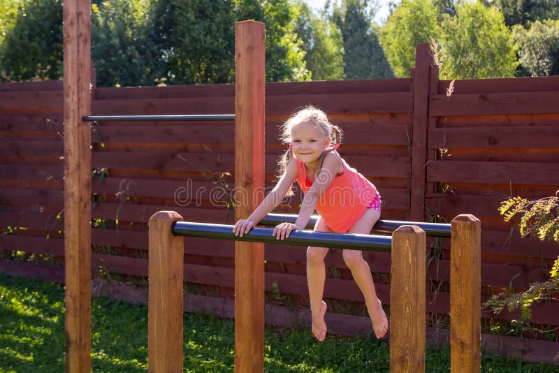 Liten flicka som utanf?r sitter p? barr arkivbild Liten flicka som utanf?r sitter p? barr arkivbild