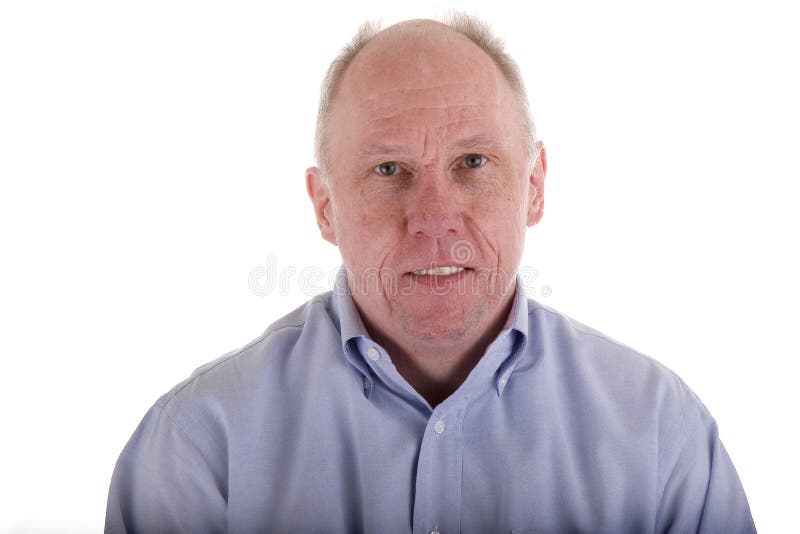 An older guy in a blue dress shirt with a slight smile. An older guy in a blue dress shirt with a slight smile