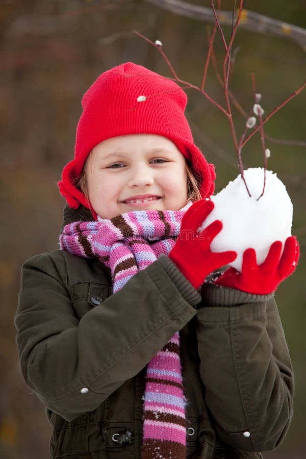 Litle girl making snowballs