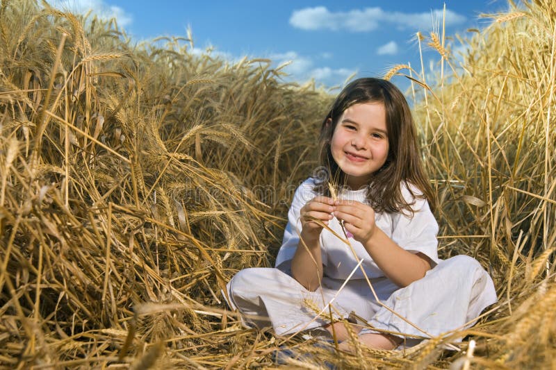 Littel girl in a wheat field