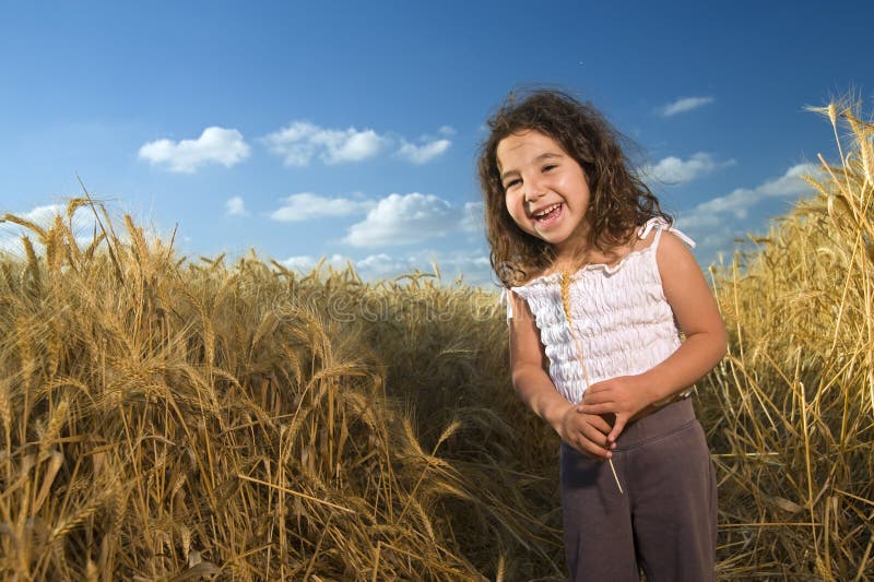 Littel girl in a wheat field