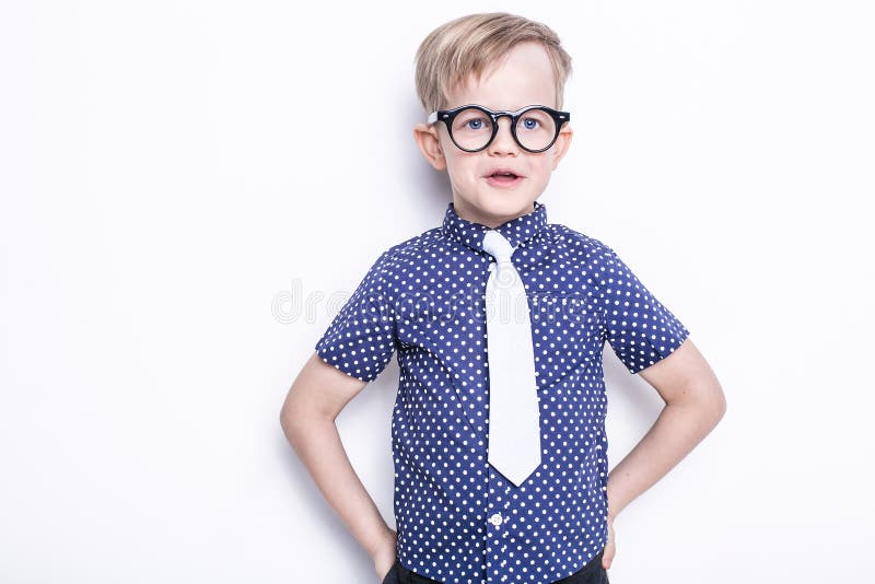 Little adorable kid in tie and glasses. School. Preschool. Fashion. Studio portrait isolated over white background stock photos Little adorable kid in tie and glasses. School. Preschool. Fashion. Studio portrait isolated over white background stock photos