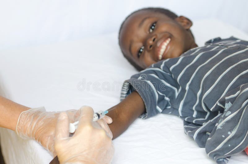 Little African Boy Getting Needle Injection from White Nurse Woman royalty free stock photo Little African Boy Getting Needle Injection from White Nurse Woman royalty free stock photo