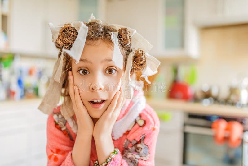 Little amazed girl with hair curlers on her head stock photos Little amazed girl with hair curlers on her head stock photos