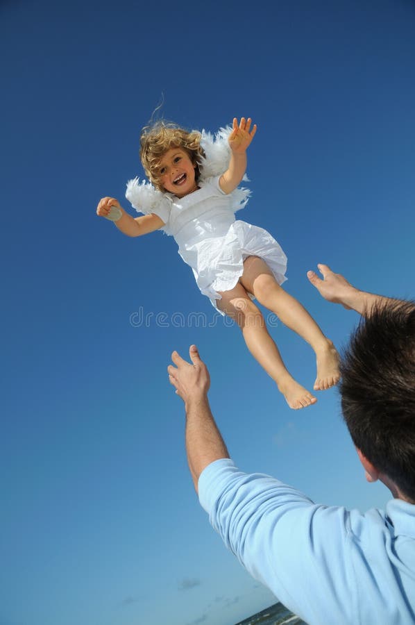 Little angel on the sky. Flying little angel on the beach Little angel on the sky. Flying little angel on the beach