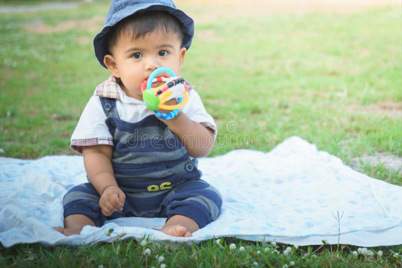 Cute little asian baby sitting in garden,vintage tone