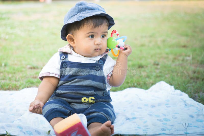 Cute little asian baby sitting in garden,vintage tone