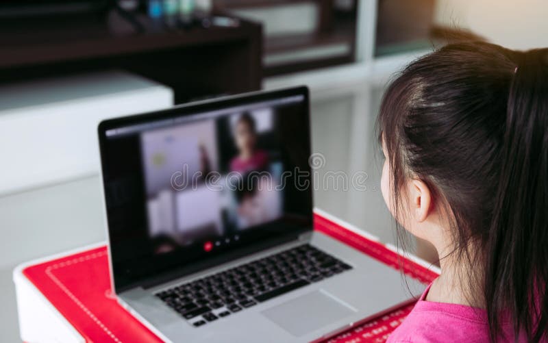 Little asian girl attending to online e-learning platform class from home while school has been closed during coronavirus outbreak