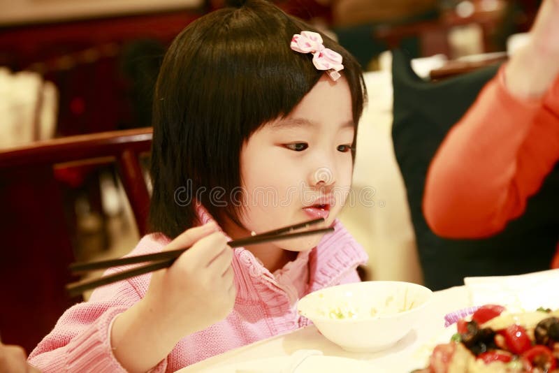 Little asian girl eating