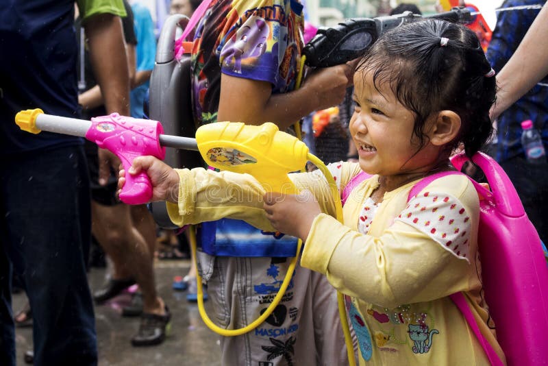 Little Asian Girl Shooting Water Gun at Songkran Festival in Ban