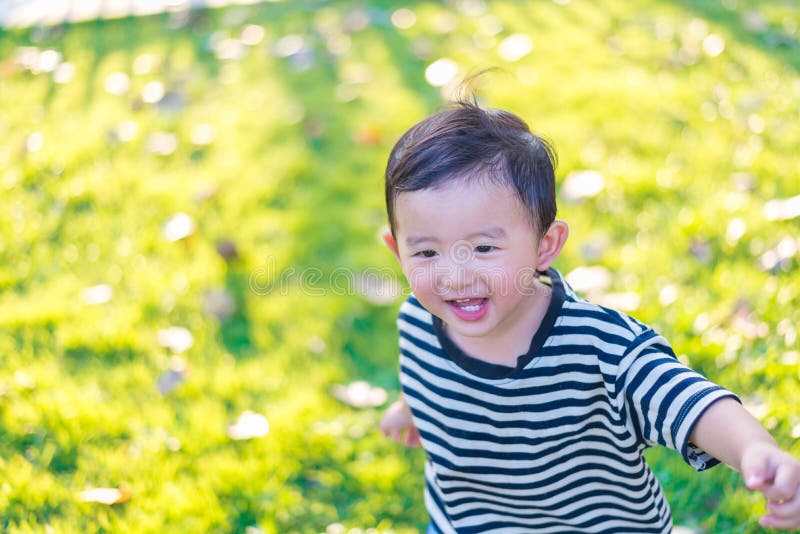 Little Asian Kid Playing Slide At The Playground Stock Image - Image of