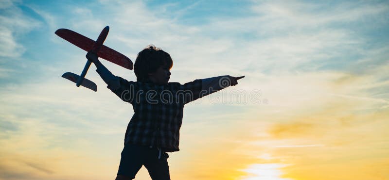 Little aviator over sunset sky. Cherishing memories of childhood. Active children concept. Kid having fun with toy airplane in field