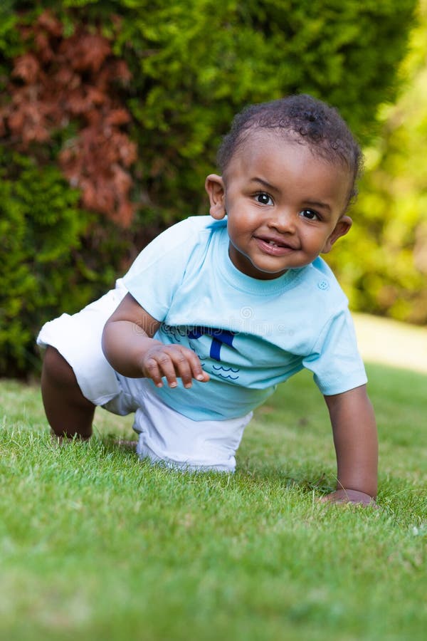 Little baby boy playing in the grass