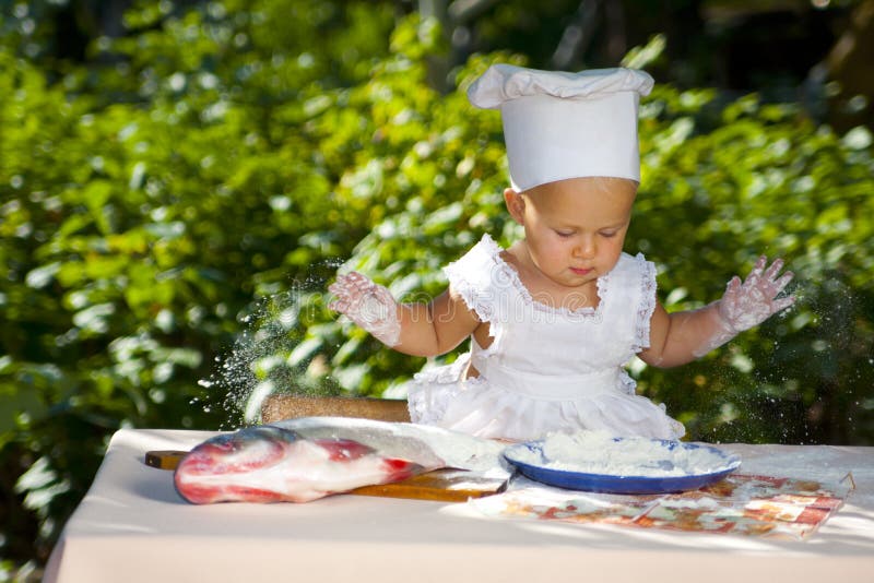 Little baby in cook hat.