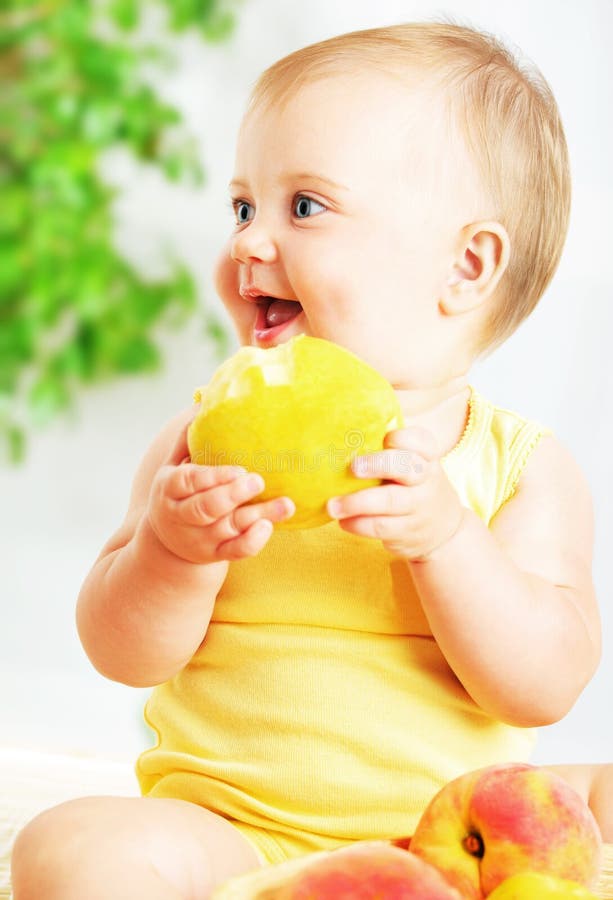 Little baby eating apple