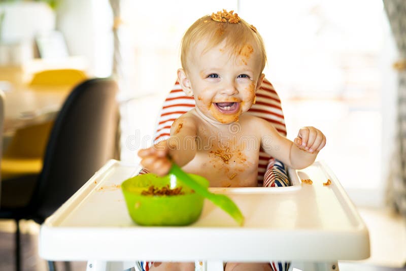 Little Baby Eating Spaghetti Dinner and Making a Mess Stock Image
